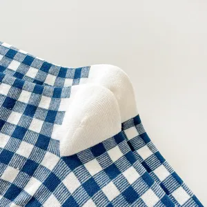 Detail view of blue and white checkered cotton socks, showing soft knit texture and pattern.