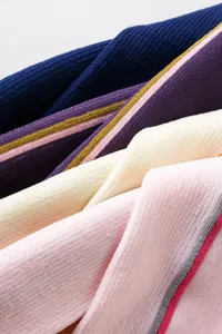 Close up detail of ribbed knit sports compression socks with colorful striped patterns.
