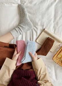 Close-up detail of cozy wool blend speckled winter socks showing soft knit texture and colors.