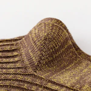 Close-up of brown and yellow colorblock chunky knit socks featuring cozy textured fabric.