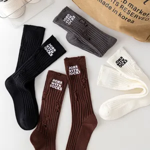 Distressed embroidered crew socks for women, thick knit ripped style cotton hosiery.