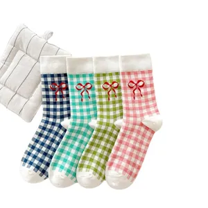 Cute plaid mid-calf socks for women featuring sweet red embroidered bow accents and soft cotton.