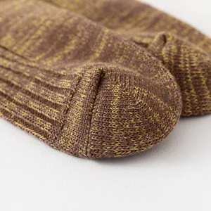 Detailed close-up shot of brown and yellow speckled knit crew socks showing soft cozy texture.