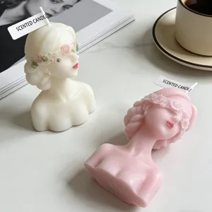 Scented candle detail, blindfolded girl bust design, aesthetic home decor, pink and white candles.