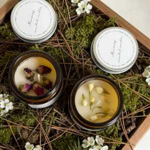 Dried flower scented candle in amber jar with rose and jasmine petals for home decor relaxation.