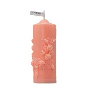 Exquisite pink pillar scented candle featuring beautiful embossed rose flower design.