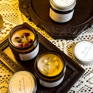 Scented candle set with dried rose and jasmine flowers in amber jars for home decor.