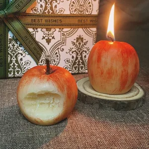 Hand-painted apple shaped scented candle detail, creative gift wax with wooden base display.