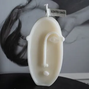 Abstract human face scented candle, European aesthetic wax home decor gift item main view.