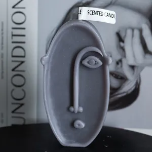 Grey abstract human face scented candle with unique artistic design for home decor and gifts.