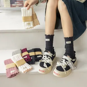 Women's ruffled mid-calf socks with vertical stripes, cute cotton knit hosiery for autumn winter.