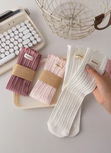 Sweet ruffled ribbed stack socks for women, cotton mid-tube socks with brand label detail.