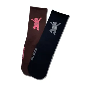 Detailed close-up of knitted couple long socks with cute dancing bear pattern and side text.
