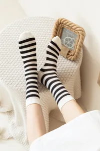 Detailed shot of breathable striped mid-tube socks, featuring mesh design for summer wear.