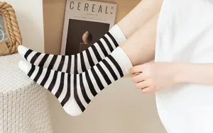 Detailed view of vintage black and white striped mesh socks, breathable summer thin socks.