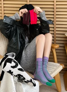 Detail view of stylish color-blocked ribbed mid-calf socks featuring contrasting toes.