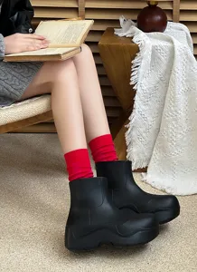 Stylish red ribbed mid-calf socks paired with black chunky boots for autumn and winter.