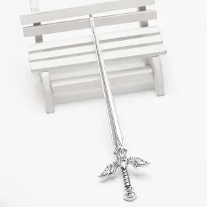 Detailed close-up of the vintage silver sword hair stick, showcasing intricate wing guard.
