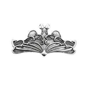 Close-up detail of vintage metal hair clip with intricate gothic scrollwork and antique finish.