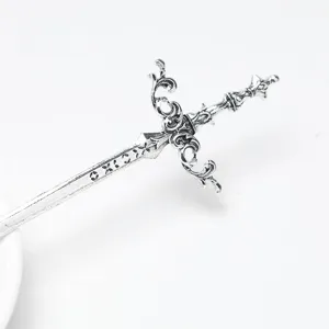 Retro sword metal hair stick detail shot, vintage silver finish hair accessory for bun.