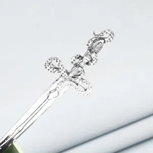 Close-up view of the vintage silver metal sword hair stick with unique tentacle design detail.