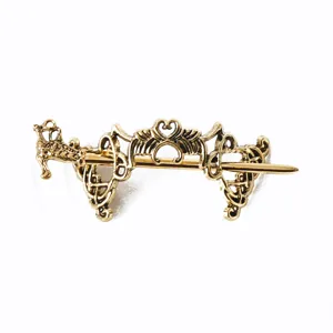 Detailed view of vintage viking dragon hair pin, intricate celtic knot metal barrette.