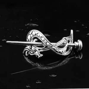 Detailed close-up of the vintage Viking Celtic dragon metal hair pin, retro silver hair fork.