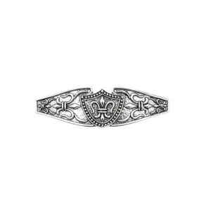 Detailed shot of vintage silver metal hair clip featuring intricate shield and motif.