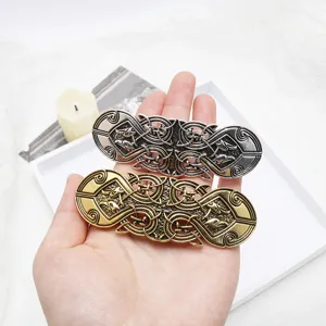 Celtic Viking hair clip detail shot showing intricate metal knotwork and bird patterns.