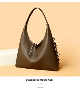 Elegant brown leather hobo shoulder bag with slouchy design, double zipper and stylish charm.