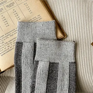 Detail view of stylish grey vertical striped casual mid-tube socks, soft knit fabric.