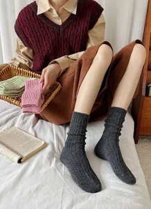 Detailed shot of women thick warm wool knit slouch socks in dark grey, cozy and stylish.