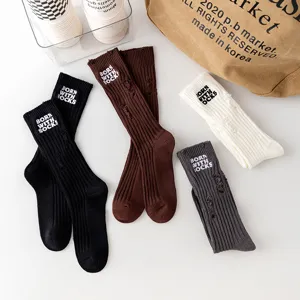 Ribbed distressed mid-calf socks with embroidered text, stylish autumn winter hosiery.