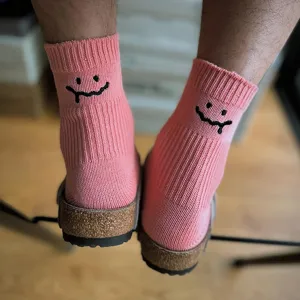 Spring dopamine pink casual cotton socks featuring trendy melting smiley embroidery detail.
