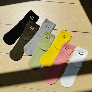 Colorful dopamine style casual short cotton socks with cute melt smile embroidery detail view.