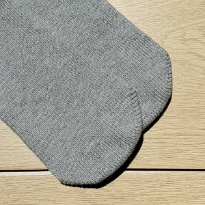 Detailed view of grey knit casual sports short socks, soft cotton fabric texture closeup.