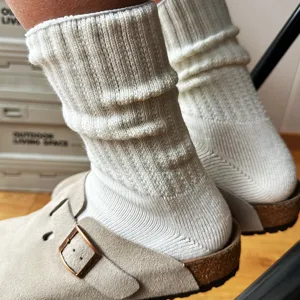 Detailed view of thick ribbed slouch socks, comfortable cotton knitwear texture for daily wear.