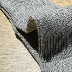 Detailed view of thick knitted gray cotton socks texture, comfortable and breathable everyday wear.