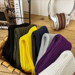 Colorful ribbed cotton crew socks neatly stacked in a wooden basket for everyday wear.