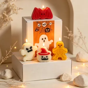 Close-up detail of Halloween scented candles set featuring ghost, bat, and pumpkin shapes.