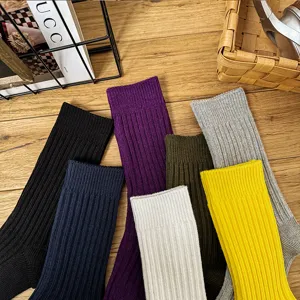Detail shot of colorful solid knit mid-calf socks flat lay, comfortable casual daily wear.