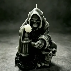 Gothic grim reaper candle detail showing intricate cloak folds, skull base and lantern sculpture.