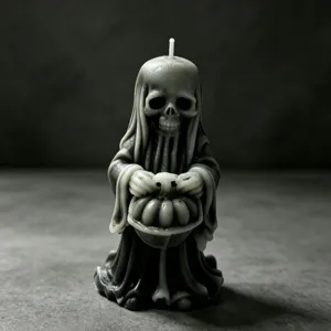 Halloween gothic skull reaper candle detail showing dark wax texture and pumpkin sculpture.
