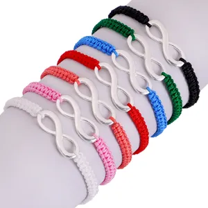 Detailed macro view of seven colorful handmade infinity braided friendship bracelets