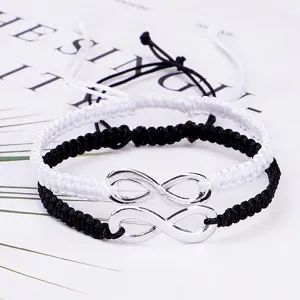 Hand-braided infinity symbol couple bracelets in black and white with silver charms