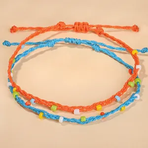 Detailed view of handmade Bohemian anklets with colorful beads and braided wax cord