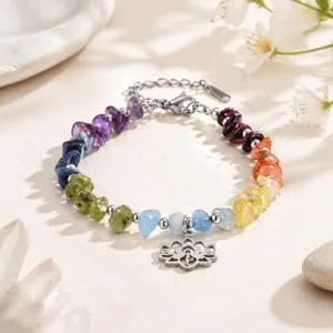 Close-up detail of colorful yoga bracelet with natural stone chips and lotus flower pendant.