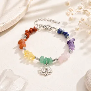 Detailed shot of chakra yoga bracelet with natural stones and silver lotus pendant charm