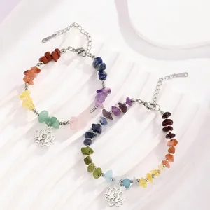 Detail view of natural stone chip yoga bracelet with stainless steel lotus pendant