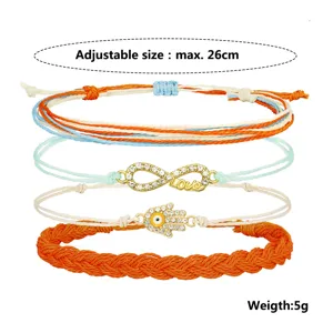 Vista dettagliata del set di bracciali bohémien in filo di cera con ciondoli infinito e Hamsa